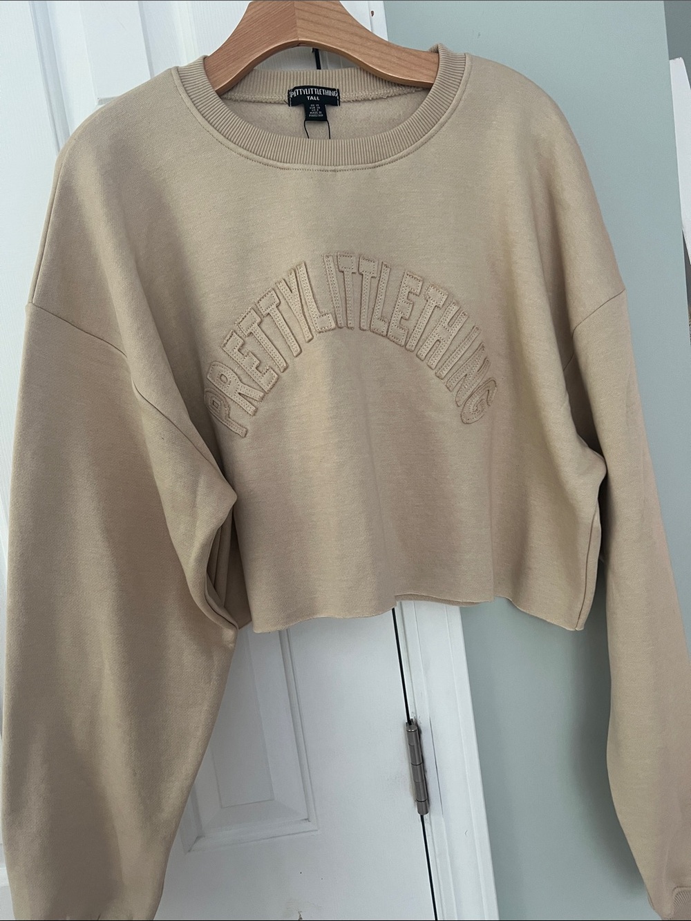 PrettyLittleThing Stone Varsity Cropped Crewneck Sweatshirt